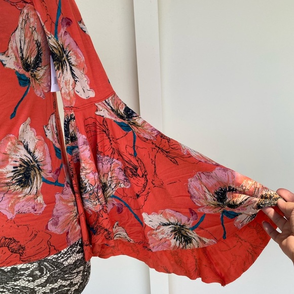 Free people top in orange with multi color floral design. Size M - Picture 5 of 5